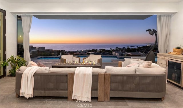 living room featuring a water view and wine cooler