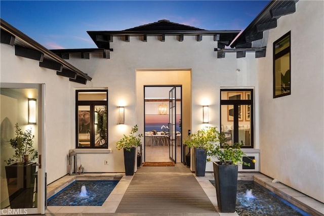 exterior entry at dusk featuring french doors