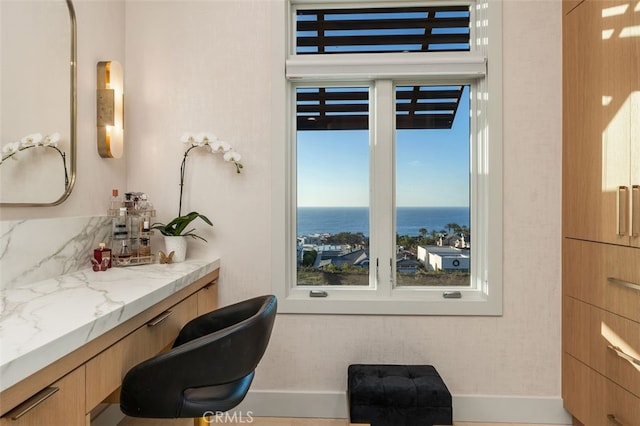 bathroom featuring vanity, a water view, and a wealth of natural light