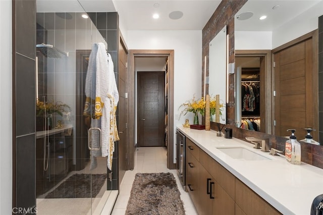 bathroom with tile patterned floors, vanity, and a shower with shower door