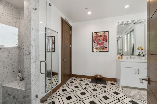 bathroom with vanity and a shower with shower door