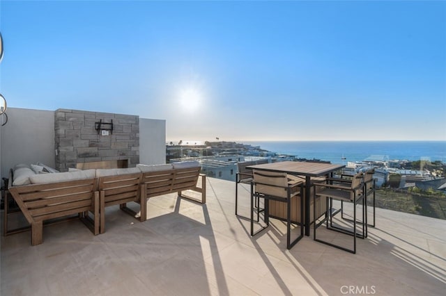 view of patio featuring a water view and an outdoor hangout area