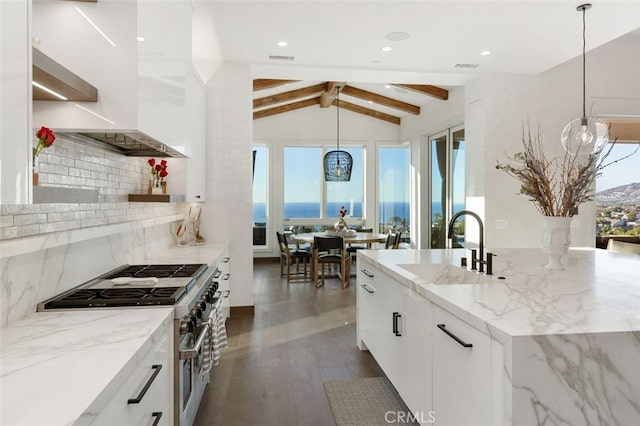 kitchen with white cabinetry, stainless steel range, decorative light fixtures, and sink