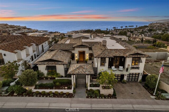 view of front of home featuring a water view and a garage