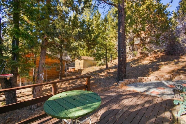 wooden deck with a storage shed