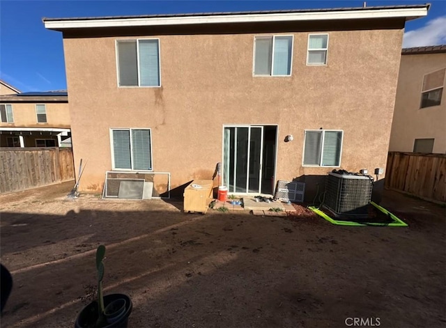 back of house featuring central AC