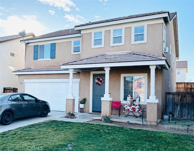 view of front property featuring a front lawn, a porch, and a garage