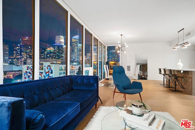 living room with light wood-type flooring and a chandelier