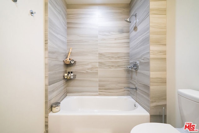 bathroom with tiled shower / bath and toilet