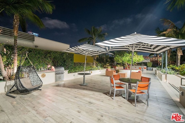 wooden deck featuring an outdoor kitchen and area for grilling