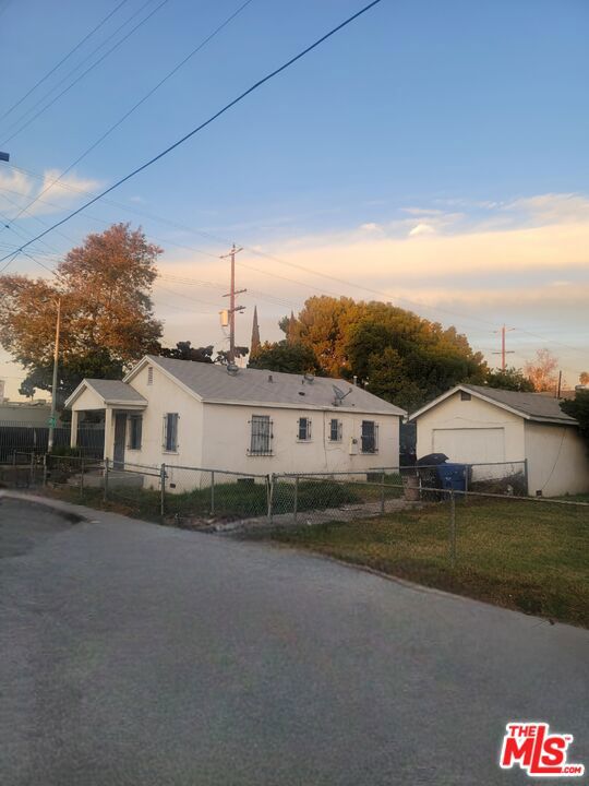 view of front facade with a garage and an outbuilding