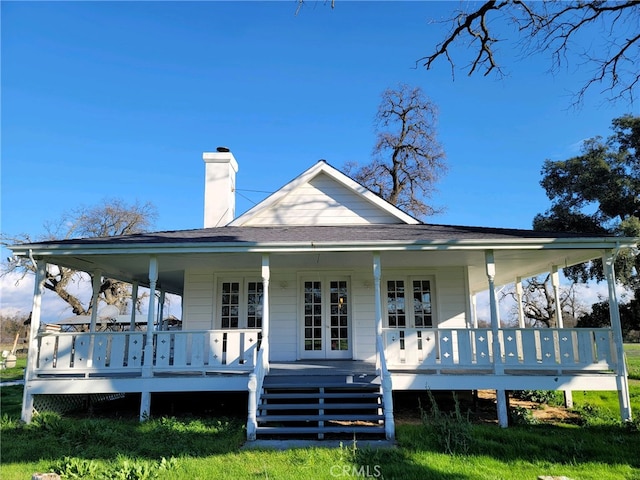 back of house featuring a porch