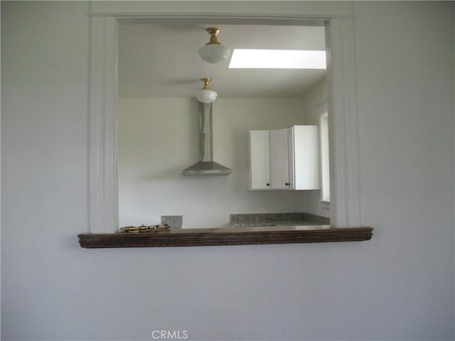 room details featuring wall chimney exhaust hood