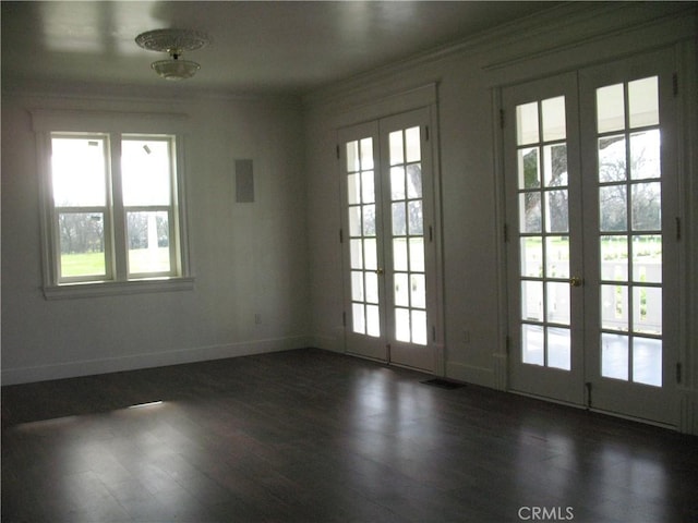 doorway to outside with french doors, dark hardwood / wood-style floors, a wealth of natural light, and ornamental molding