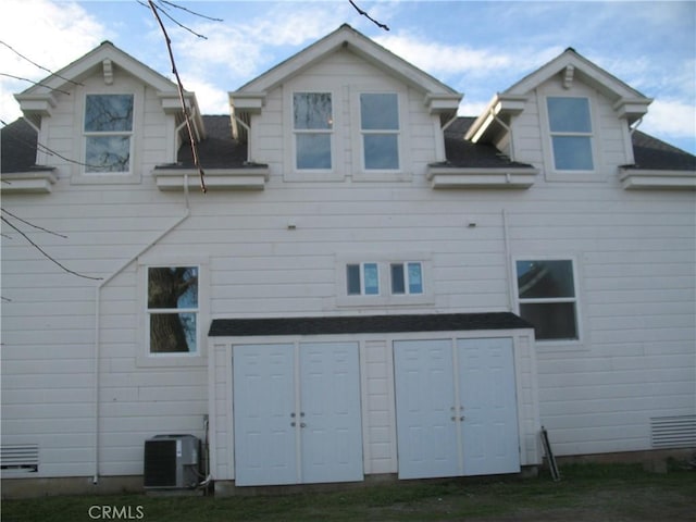 rear view of property featuring central AC unit