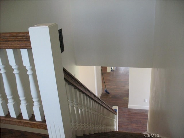 staircase with hardwood / wood-style floors