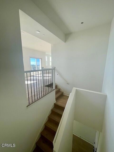 stairway featuring wood-type flooring