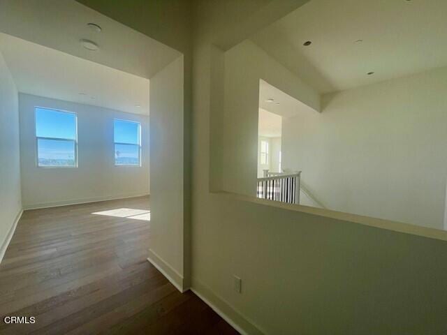 hallway with hardwood / wood-style flooring