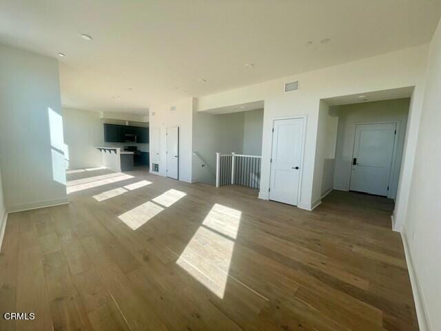 unfurnished room with wood-type flooring