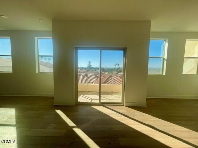 interior space with baseboards and wood finished floors