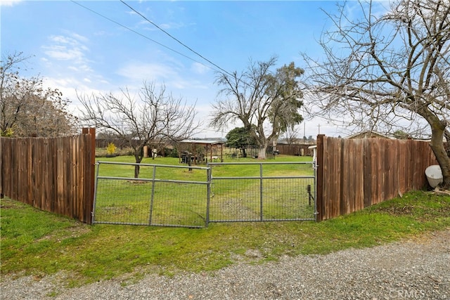 view of gate featuring a lawn