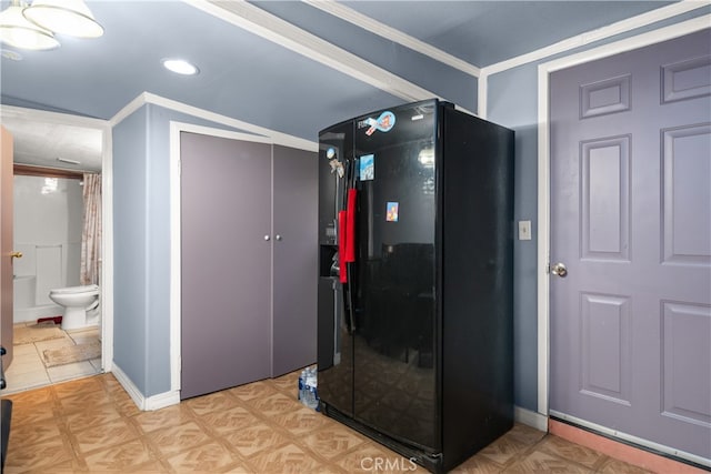 interior space featuring black fridge and crown molding