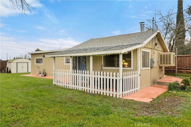 view of front of house featuring a front yard and a shed