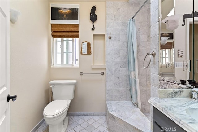 bathroom with tile patterned flooring, toilet, vanity, and walk in shower