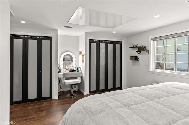 bedroom with dark hardwood / wood-style floors