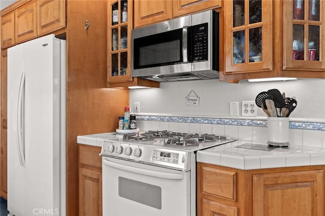 kitchen with white appliances and tile countertops