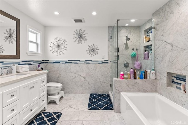 full bathroom with separate shower and tub, vanity, tile walls, and toilet