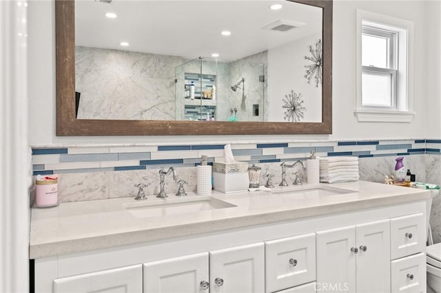 bathroom featuring vanity, toilet, and a shower with door