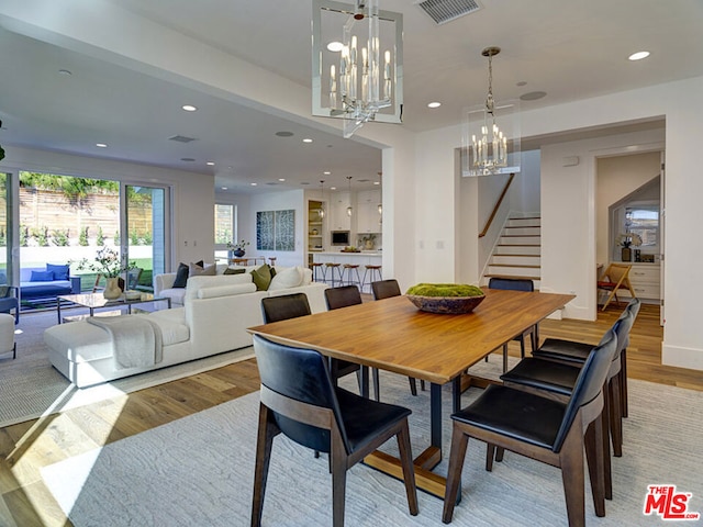 dining room featuring an inviting chandelier and light wood-type flooring