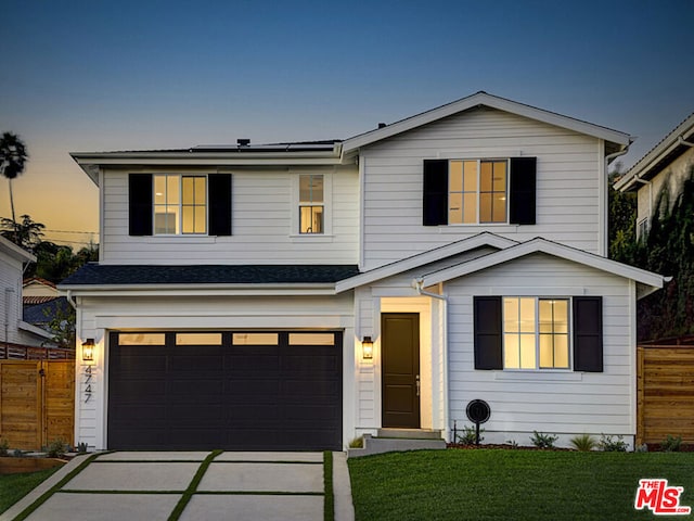 view of front of home featuring a yard and a garage