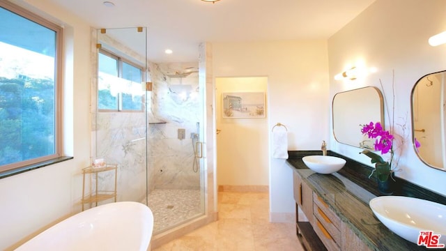 bathroom with tile patterned flooring, vanity, and shower with separate bathtub