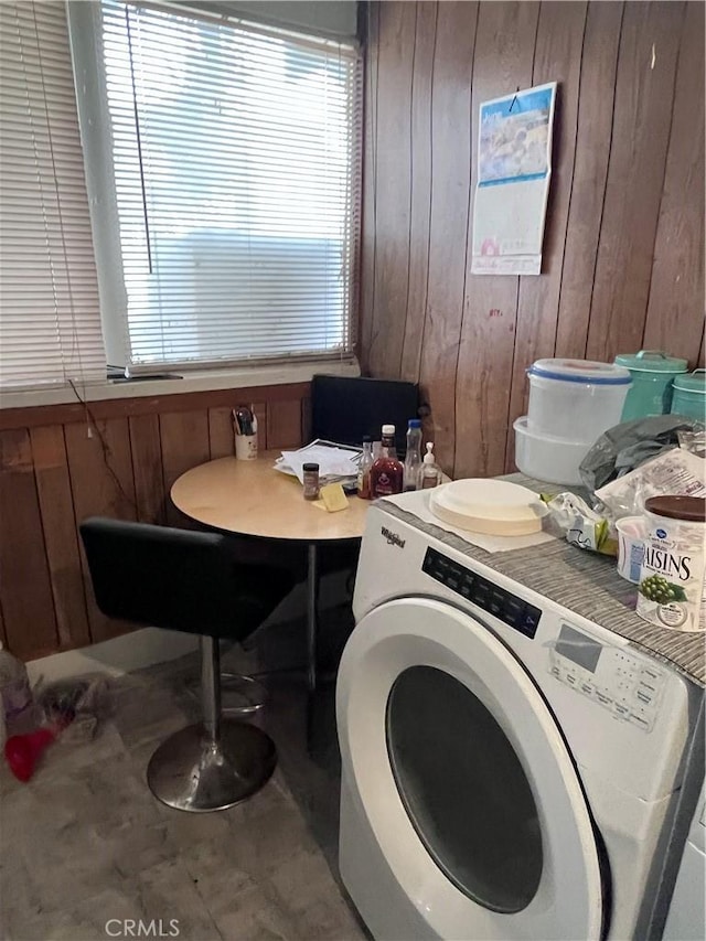 laundry area featuring tile flooring, washer / clothes dryer, and wood walls