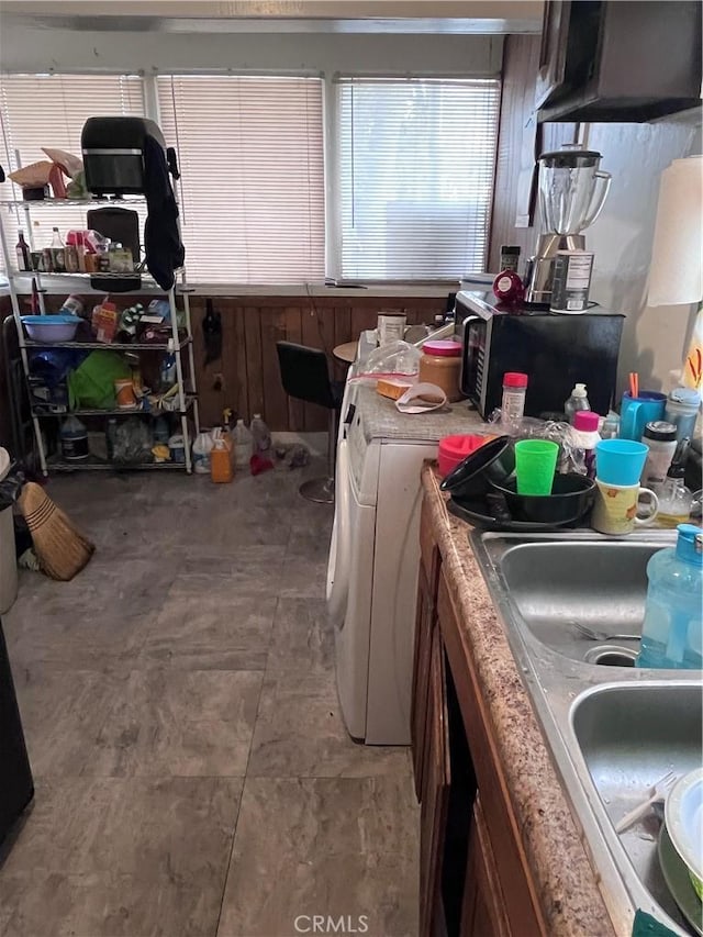 kitchen featuring tile floors, sink, and washer and clothes dryer