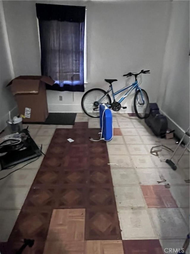 workout room with parquet flooring