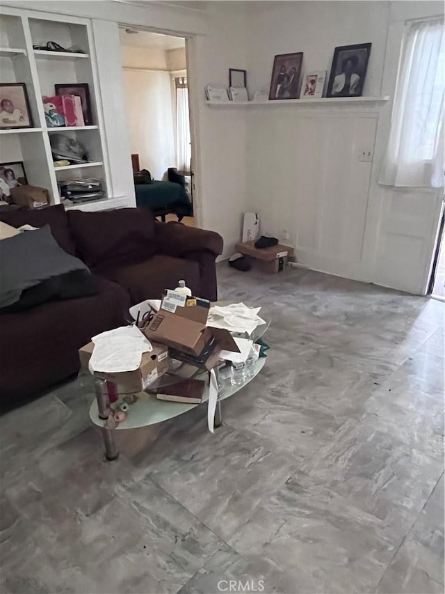 living room with tile flooring and built in shelves