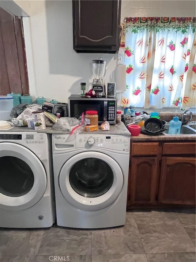 laundry area with cabinets, independent washer and dryer, and light tile floors