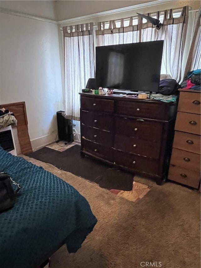 carpeted bedroom featuring multiple windows