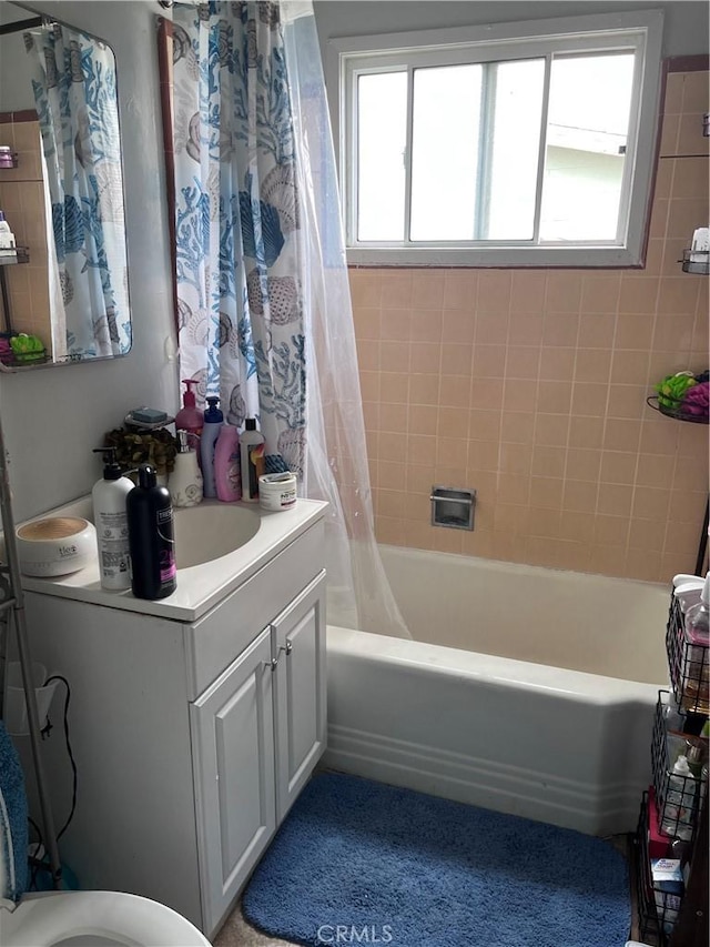 full bathroom with vanity, toilet, and shower / bath combo with shower curtain