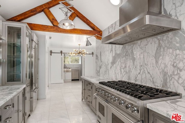 kitchen with high end stainless steel range oven, light stone countertops, wall chimney range hood, and gray cabinets