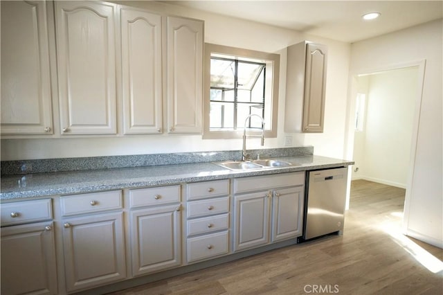 kitchen with dishwasher, light hardwood / wood-style floors, white cabinetry, and sink