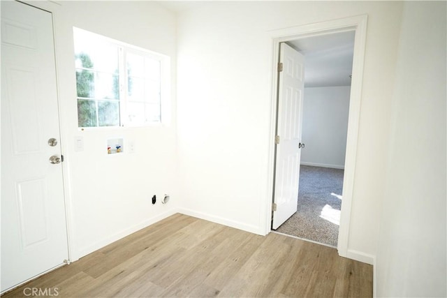 washroom featuring hookup for a washing machine and light hardwood / wood-style flooring