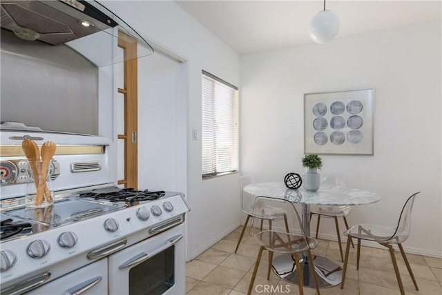 kitchen with white cabinetry, double oven range, light tile patterned floors, and range hood