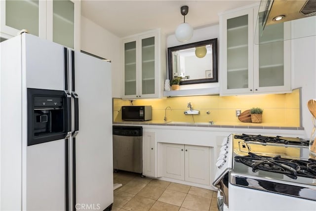 kitchen featuring range with gas stovetop, dishwasher, white cabinets, hanging light fixtures, and white fridge with ice dispenser