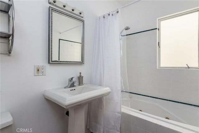 full bathroom with sink, shower / tub combo with curtain, and toilet