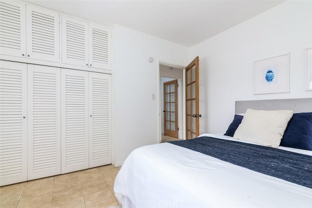 tiled bedroom with a closet