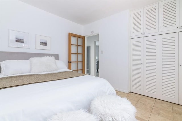 tiled bedroom featuring a closet